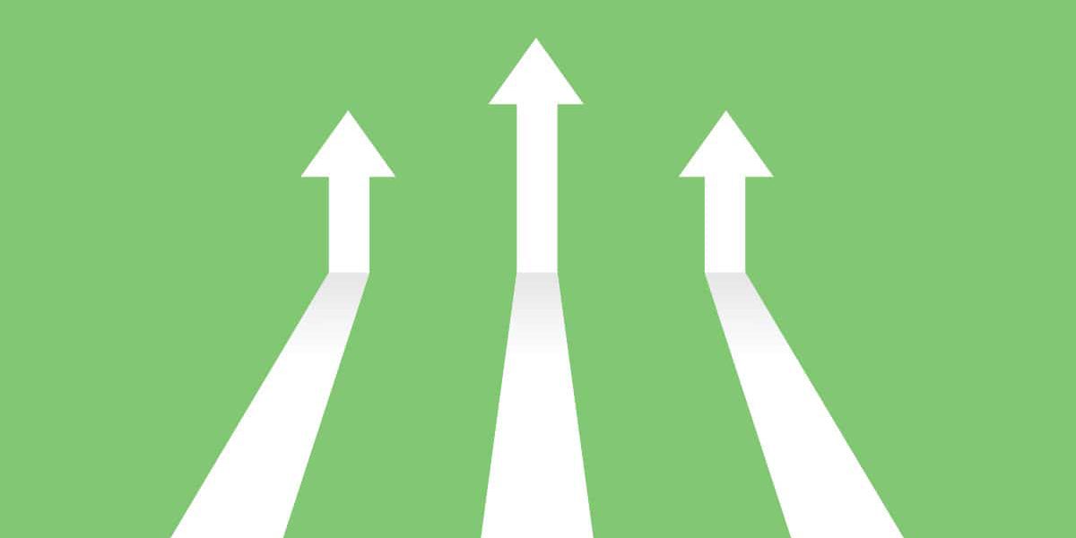 Digital Marketing Trends to Watch in 2023 Vector illustration image of white arrows on green background coming in and pointing up to depict increasing trends. Specifically, indicating the topic of the blog post which is digital trends in 2023.