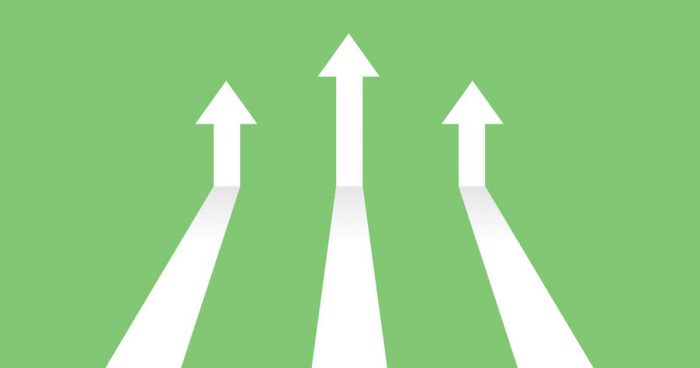 Vector illustration image of white arrows on green background coming in and pointing up to depict increasing trends. Specifically, indicating the topic of the blog post which is digital trends in 2023.